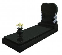 A Black granite memorial with carved roses.