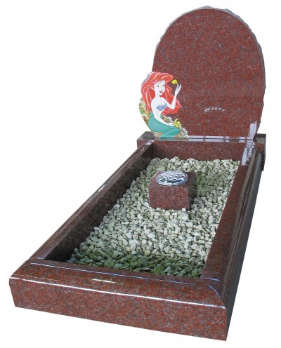 An Indian Ruby Red granite childs memorial, with a coloured ornament.